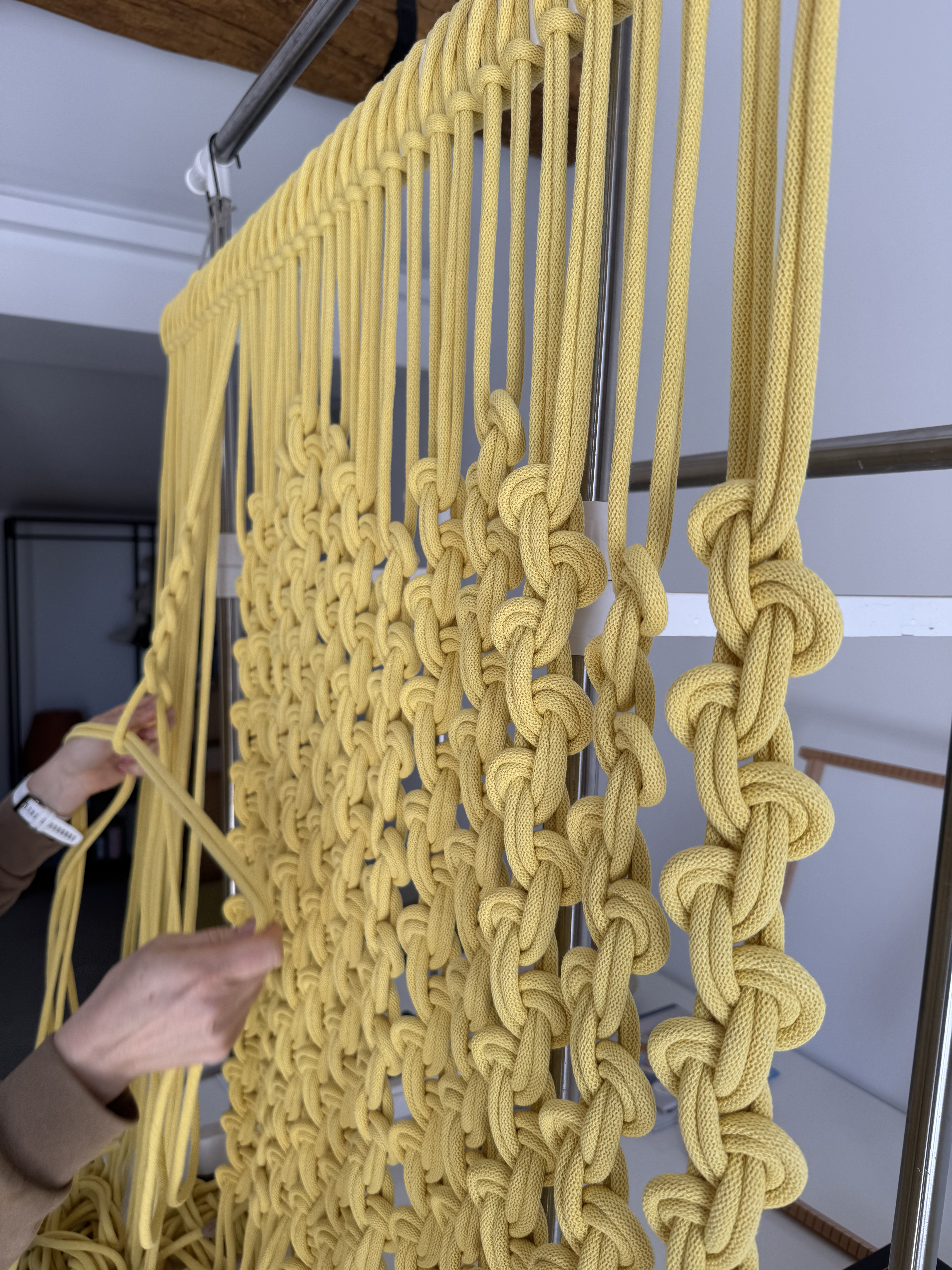 Hands knotting — the making